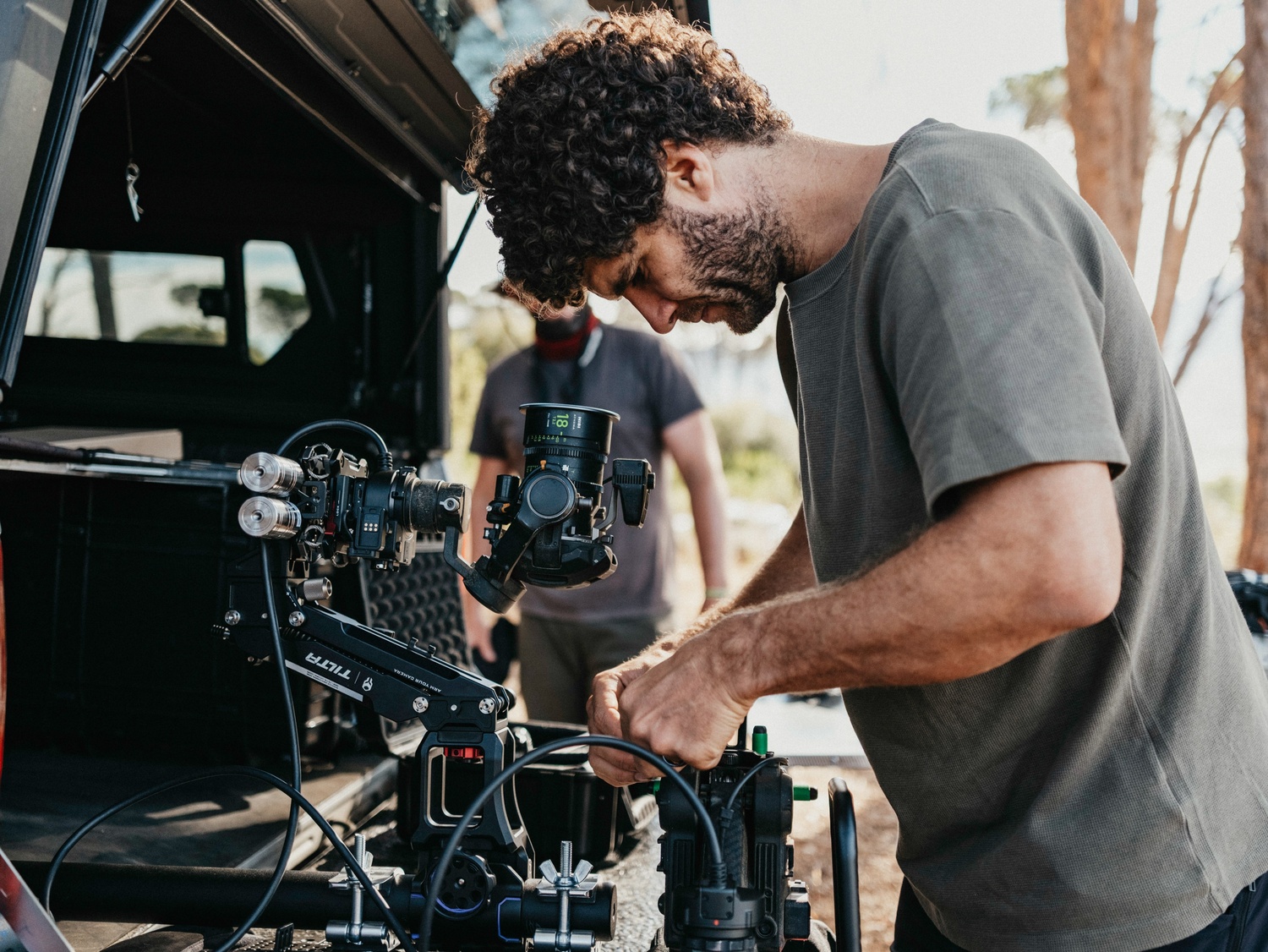 A cameraman director preparing a DJI Ronin 4D gimbal rig